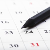 Check out the dates in a business calendar concept